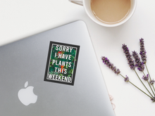 Load image into Gallery viewer, Sorry I Have Plants This Weekend sticker on silver laptop with coffee and lavender