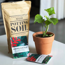 Load image into Gallery viewer, Indoor potting soil bag with instant plant food fertilizer tablets next to potted green plant