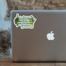 Load image into Gallery viewer, Humorous plant-themed sticker on laptop back reading don't let fear of space keep you from buying more plants