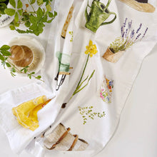Load image into Gallery viewer, White cotton tea towels with botanical garden prints including lavender, daffodil, and watering can designs