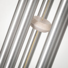 Load image into Gallery viewer, Wind chime with light wood bead suspended on yellow cord between silver metal tubes
