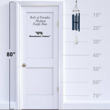 Load image into Gallery viewer, Woodstock Chimes Bells of Paradise wind chime in Pacific Blue showing size comparison against door