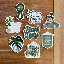 Load image into Gallery viewer, Collection of plant-themed stickers with botanical quotes and illustrations on wooden background