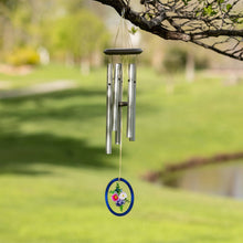 Load image into Gallery viewer, Wind chime with silver tubes and blue floral medallion hanging from tree branch in garden
