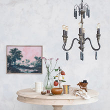 Load image into Gallery viewer, Framed landscape artwork with trees and pink sky displayed on white wall above wooden table