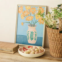 Load image into Gallery viewer, Framed painting of orange flowers in decorative vase with green leaf pattern on blue background