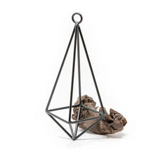 Load image into Gallery viewer, Black metal geometric pyramid terrarium with hanging loop containing brown decorative rocks