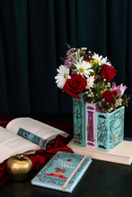 Load image into Gallery viewer, Triple book vase with fairy tale designs holding mixed flowers including red roses and white daisies