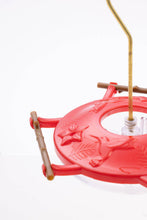 Load image into Gallery viewer, Red hummingbird feeder with bamboo perches and decorative hummingbird design on circular base