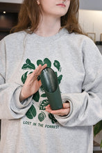Load image into Gallery viewer, Green plastic soil scoop with ribbed handle being held by person in plant-themed sweatshirt