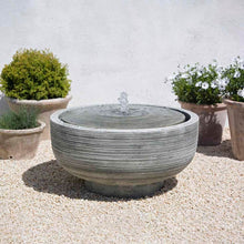Load image into Gallery viewer, Modern concrete water fountain with ribbed texture and central water spout in garden setting