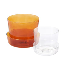 Load image into Gallery viewer, Translucent amber glass pot with matching saucer alongside a clear glass pot and saucer