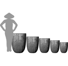 Load image into Gallery viewer, Five Crucible Glazed Planters in graduated sizes shown next to human silhouette for scale