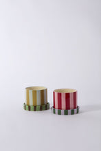 Load image into Gallery viewer, Two striped ceramic plant pots with matching saucers in olive-gold and crimson-pink colorways