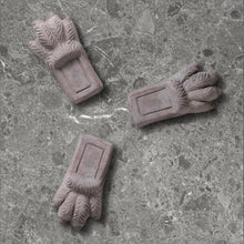 Load image into Gallery viewer, Three terracotta pot feet with decorative leaf designs on concrete surface