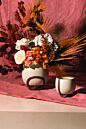 Load image into Gallery viewer, White ceramic footed planter pot with dried flower arrangement on pink backdrop