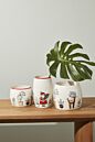 Load image into Gallery viewer, Three festive Christmas-themed ceramic plant pots with holiday character designs on wooden surface