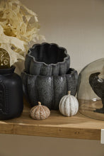 Load image into Gallery viewer, Dark speckled ceramic pumpkin-shaped planters stacked together with two small decorative pumpkins in front