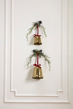 Load image into Gallery viewer, Two gold hammered metal Christmas bells with red velvet bows and greenery wall decoration